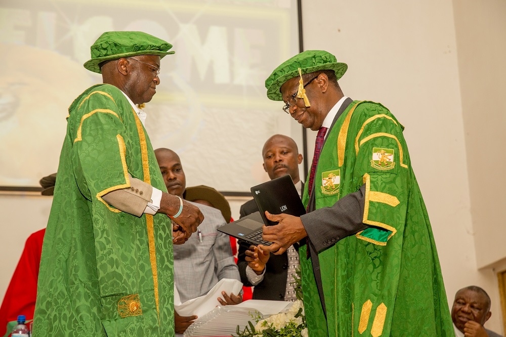 Hon Minister of Power Works  Housing and Guest Lecturer Mr Babatunde FasholaSANleft and Vice  Chancellor University of NigeriaNsukka ProfBenjamin Chukwuma Ozumbarightpresenting one of the Laptop computers made by the University of Nigeria to the Hon Minister shortly after he delivered theSpecial Herbert Macaulay Memorial Lectureorganized by the University of Nigeria Nsukka at the Princess Alexandra AuditoriumPAA Nsukka Enugu State on Monday 2nd July 2018